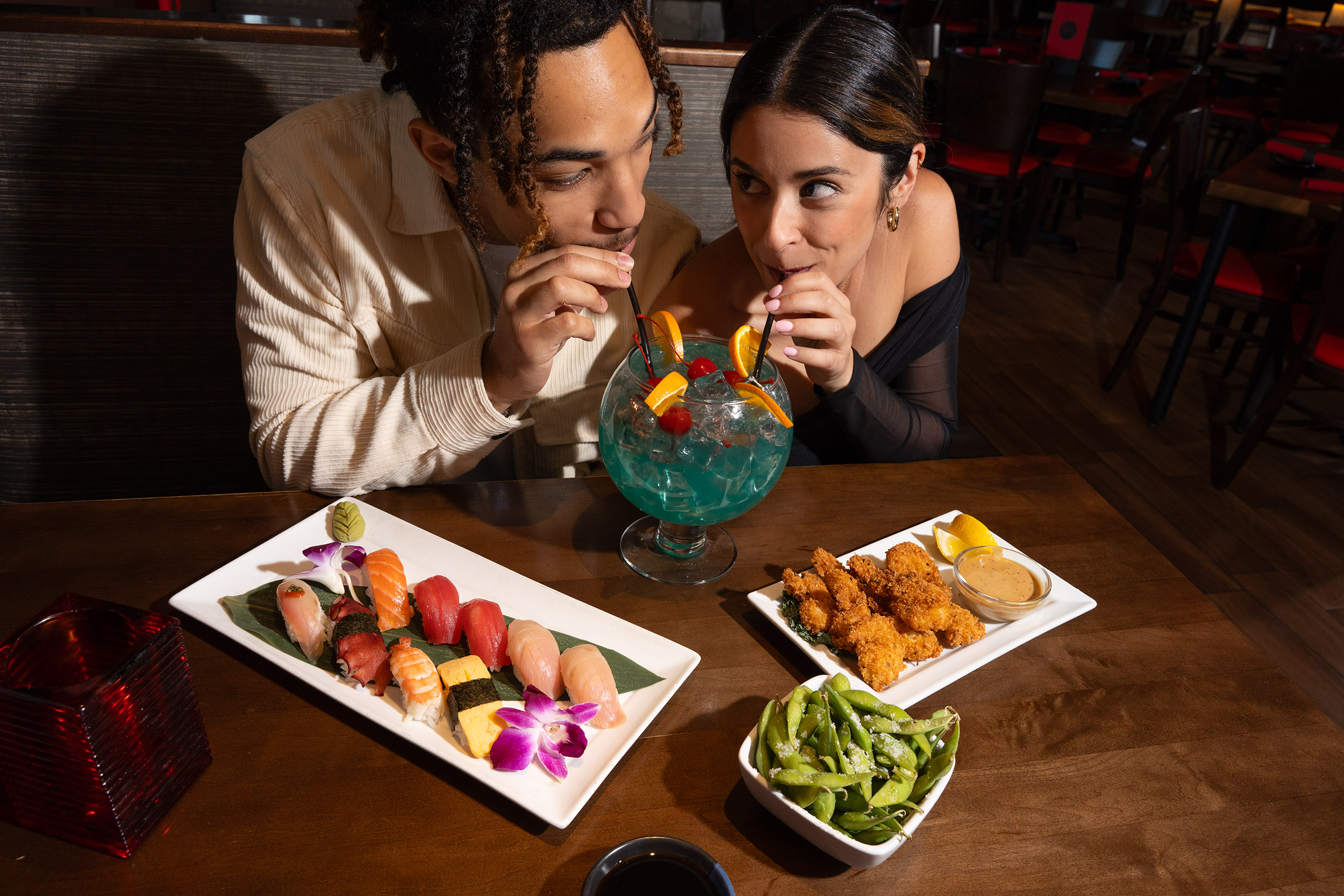 One drink, two straws, endless vibes. Cheers to good sushi and even better company.